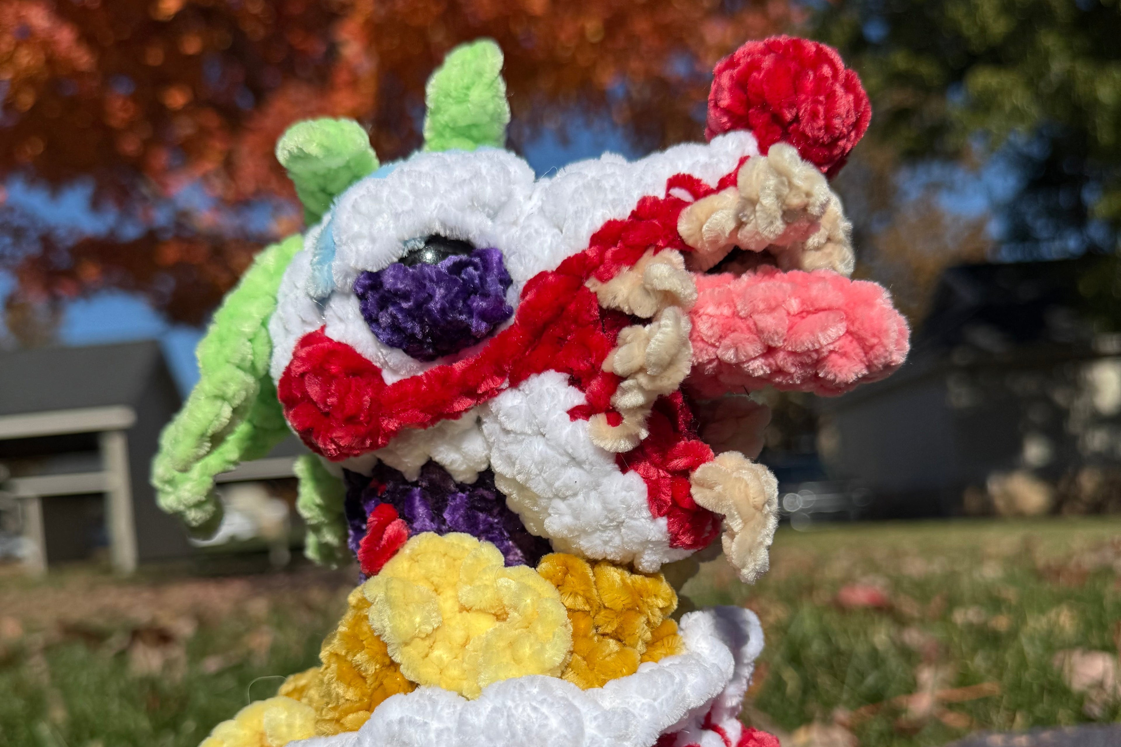 Colorful crochted killer klown from killer klowns from outer space in crochet popcorn bucket. 